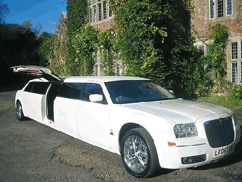 Chauffeur driven stretch limo white Chrysler C300 Baby Bentley with jet doors available in Brighton, Eastbourne, Hastings, Portsmouth, Crawley, Tunbridge Wells, Lewes, Worthing, Chichester, Bognor Regis, Horsham, East Grinstead, East Sussex and West Sussex.