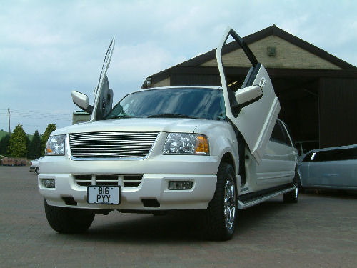 Chauffeur stretch white Ford Excursion 4x4 limousine hire with Lamborghini doors in Sheffield, Rotherham, Barnsley, Doncaster, Huddersfield, South Yorkshire.