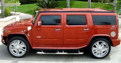 Chauffeur stretch burnt orange Baby Hummer H2 limousine hire in London, Berkshire, Surrey, Buckinghamshire, Hertfordshire, Essex, Kent, Hampshire, Northamptonshire