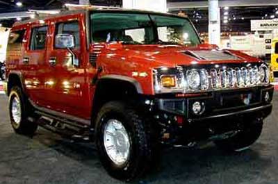 Chauffeur driven burnt orange Baby Hummer H2 hire in Liverpool, Manchester, Bolton, Warrington, North West
