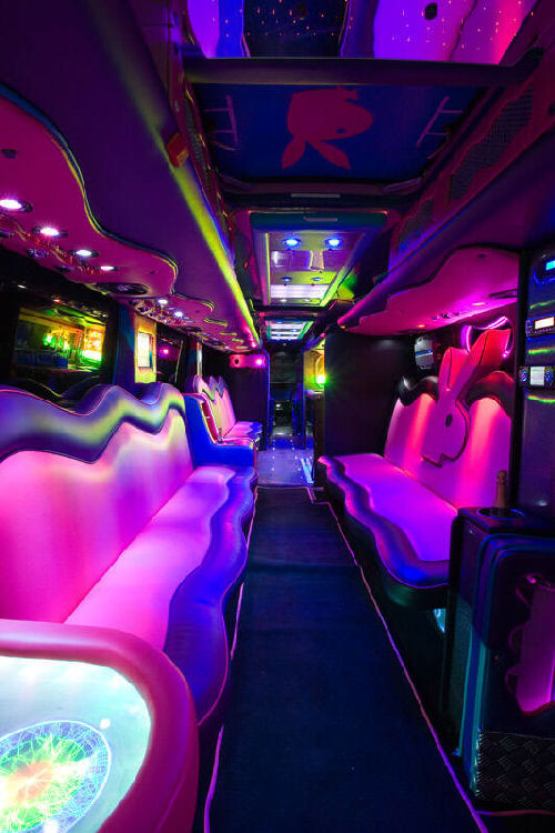 Chauffeur driven Party Bus limousine hire Playboy den interior in Bristol, Gloucester, Cheltenham, Cardiff, Wales, Weston Super Mare, and Bath.