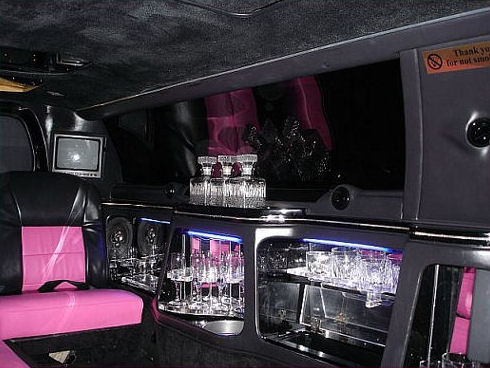 Chauffeur stretched pink limousine hire interior in UK