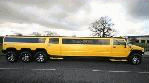Chauffeur driven stretch yellow 8-wheeler triple axle H2 hummer limousine in Manchester, Liverpool, Cheshire, Chester, Stockport, North West, Blackburn, Preston, Bolton, Wigan, Lancashire.