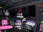 Chauffeur stretched pink limousine hire interior in UK